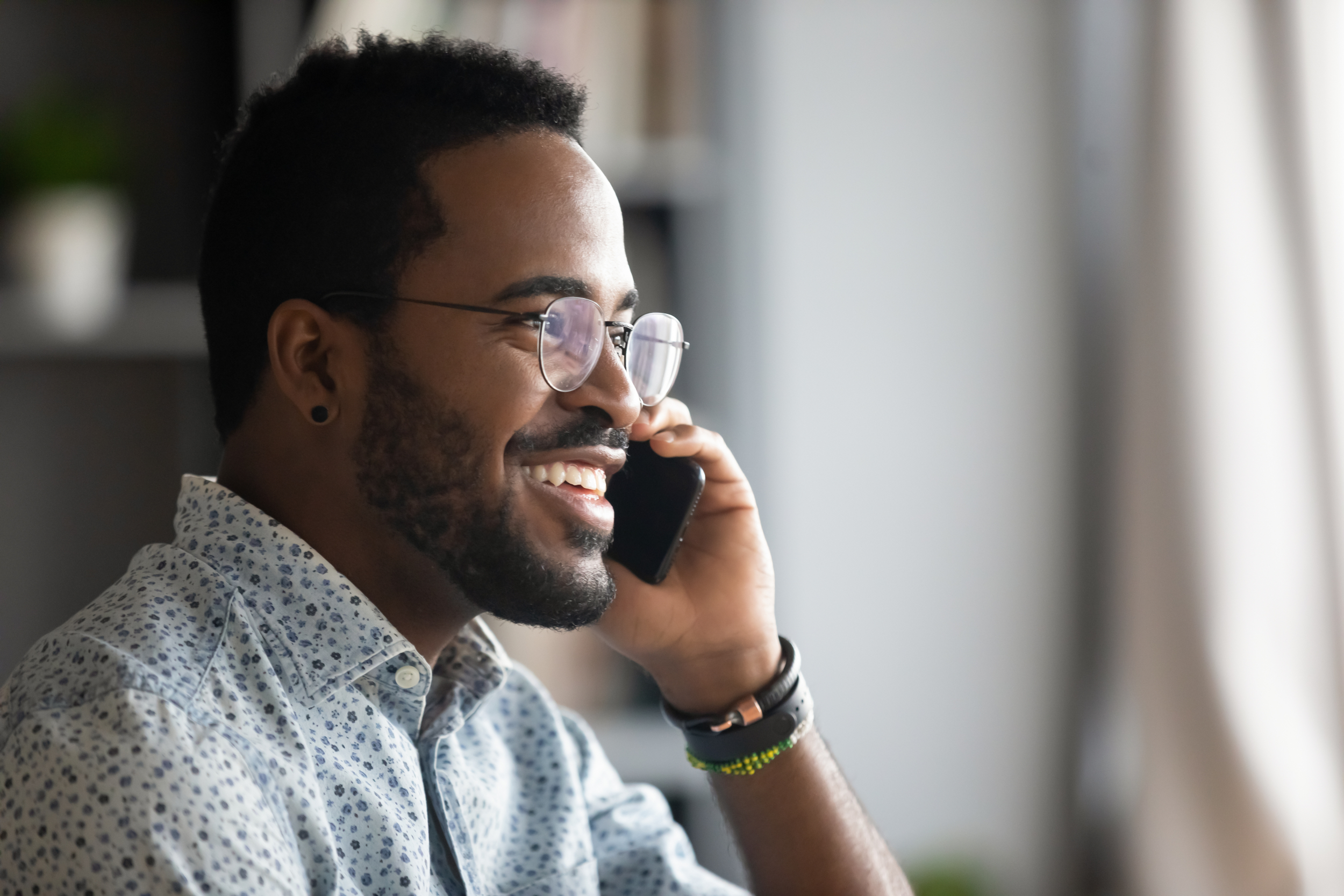 Young man on a phone call with freerateupdate.com to get rates from a qualified mortgage lender