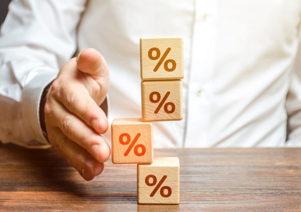 Man adding percent block to stack of percent blocks